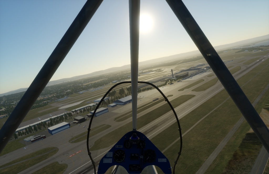 A screenshot from X-Plane 12 of the view from an ultralight over Portland's airport in the late afternoon.